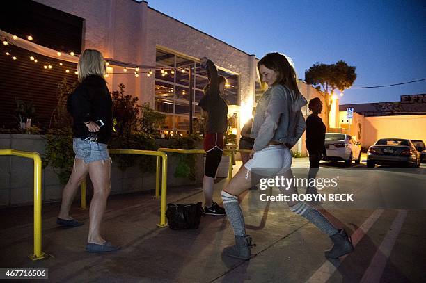 By Guillaume Meyer, Lifestyle-US-dance Women stretch out before the doors open for the Daybreaker LA morning dance party, at the Springs in downtown...