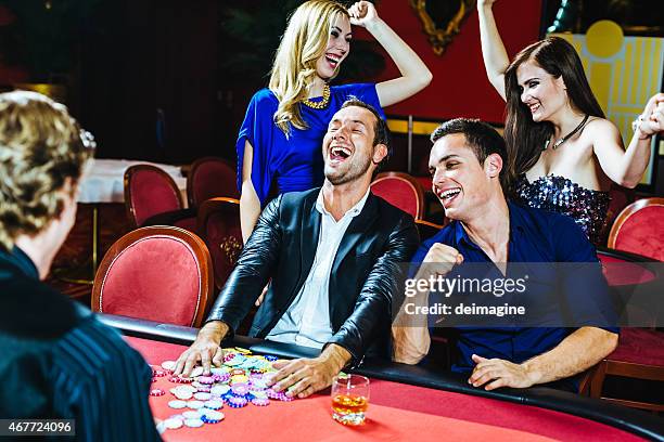 winnings at the poker table - poker dealers stock pictures, royalty-free photos & images