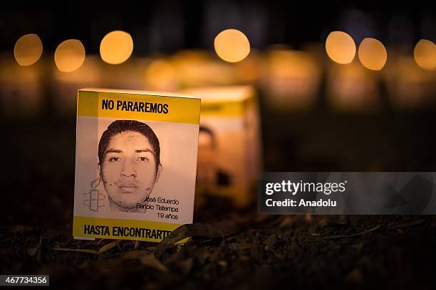 Portrait of a missing student is seen during a protest in Mexico City, on March 26, 2015 to demand justice for 43 students from Ayotzinapa College...