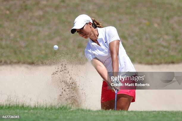 Cheyenne Woods of the United States chips out of the bunker on the 1st hole during day three of the 2014 Ladies Masters at Royal Pines Resort on...