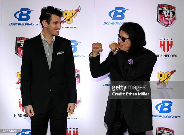 Television personality Nick Simmons and his father, Kiss singer/bassist Gene Simmons, joke around as they arrive at the sixth annual Fighters Only...