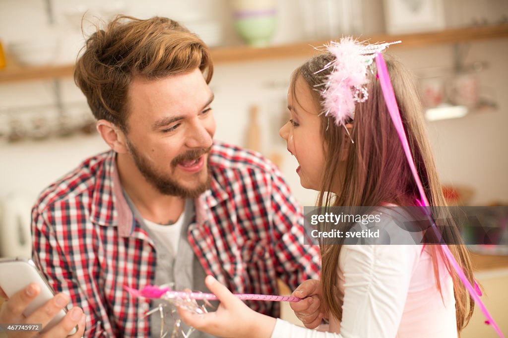 Father and daughter talking in kitchen.