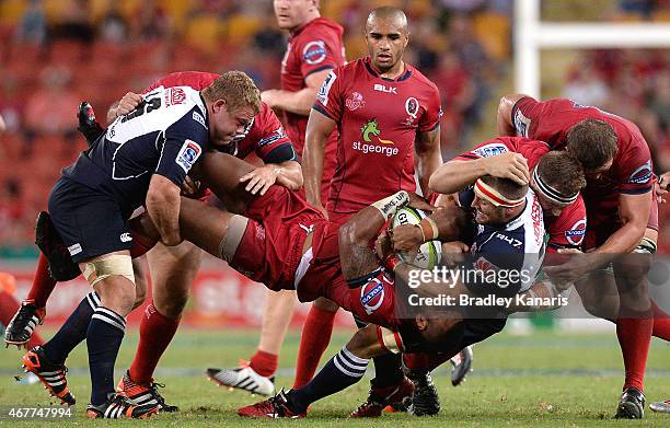 Samu Kerevi of the Reds is picked up in the tackle during the round seven Super Rugby match between the Reds and the Lions at Suncorp Stadium on...