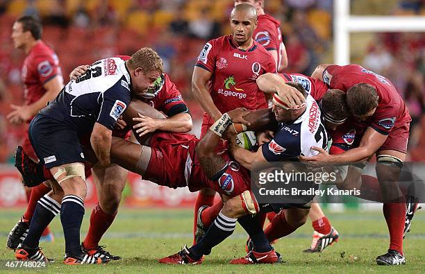 Samu Kerevi of the Reds is picked up in the tackle during the round seven Super Rugby match between the Reds and the Lions at Suncorp Stadium on...