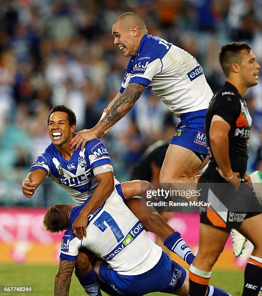 Moses Mbye of the Bulldogs celebrates his winning field goal in golden point time with team mates Trent Hodkinson and David Klemmer during the round...