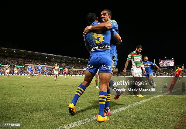 Reece Robinson of the Eels celebrates scoring a try with team mate Will Hopoate during the round four NRL match between the Parramatta Eels and the...