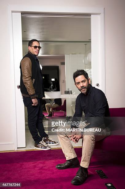 French actors Didier Morville aka JoeyStarr and Manu Payet pose on March 27, 2015 in Paris. AFP PHOTO MARTIN BUREAU