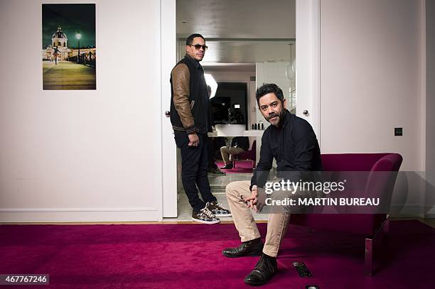 French actors Didier Morville aka JoeyStarr and Manu Payet pose on March 27, 2015 in Paris. AFP PHOTO MARTIN BUREAU