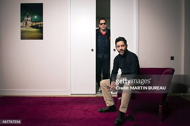 French actors Didier Morville aka JoeyStarr and Manu Payet pose on March 27, 2015 in Paris. AFP PHOTO MARTIN BUREAU