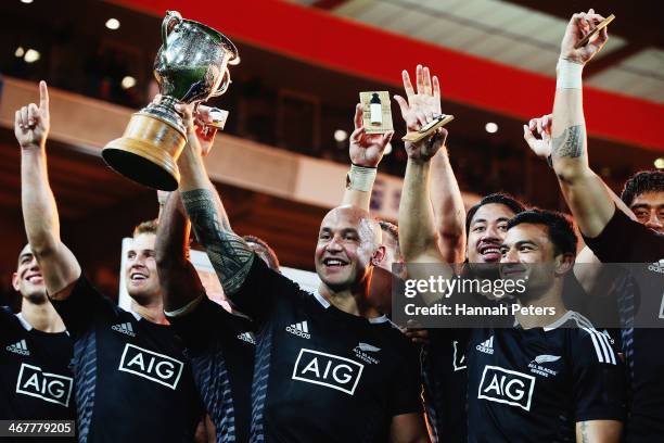 Forbes of New Zealand holds up the Sevens trophy after winning the final match between New Zealand and South Africa at Westpac Stadium on February 8,...