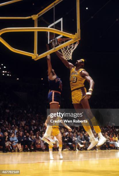 Wilt Chamberlain of the Los Angeles Lakers looks to block the shot attempt of Walt Frazier of the New York Knicks during the 1971-1972 season at the...