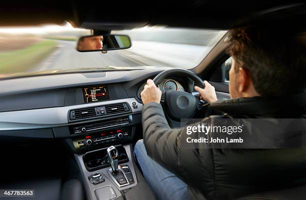 at the wheel - car speeding imagens e fotografias de stock