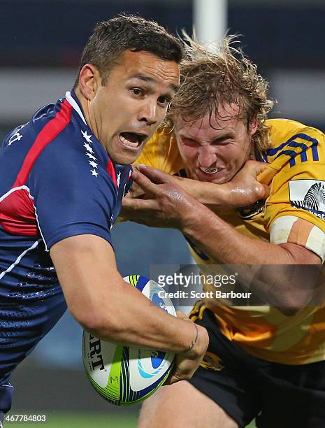 Tamati Ellison of the Rebels is tackled by Hadleigh Parkes of the Hurricanes during the Super Rugby trial match between the Rebels and the Hurricanes...
