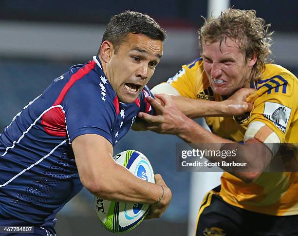 Tamati Ellison of the Rebels is tackled by Hadleigh Parkes of the Hurricanes during the Super Rugby trial match between the Rebels and the Hurricanes...