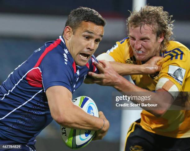 Tamati Ellison of the Rebels is tackled by Hadleigh Parkes of the Hurricanes during the Super Rugby trial match between the Rebels and the Hurricanes...