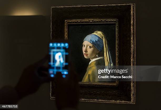 Visitor takes a picture of Vermeer's "La ragazza con l'orecchino di perla" at Palazzo Fava on February 8, 2014 in Bologna, Italy. The exhibition "The...