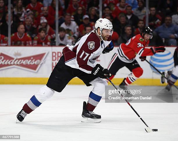 Brad Stuart of the Colorado Avalanche breaks up the ice on his way to scoring a third period goal against the Chicago Blackahwks at the United Center...