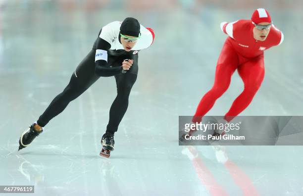 Mathieu Giroux of Canada and Jan Szymanski of Poland compete during the Men's 5000m Speed Skating event during day 1 of the Sochi 2014 Winter...