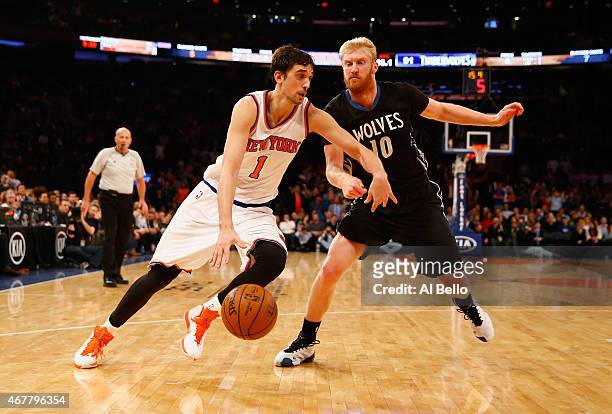 Alexey Shved of the New York Knicks drives against Chase Budinger of the Minnesota Timberwolves during their game at Madison Square Garden on March...