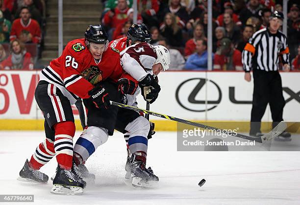 Cody McLeod of the Colorado Avalanche tries to get off a shot under pressure from Kyle Cumiskey and Brent Seabrook of the Chicago Blackhawks at the...