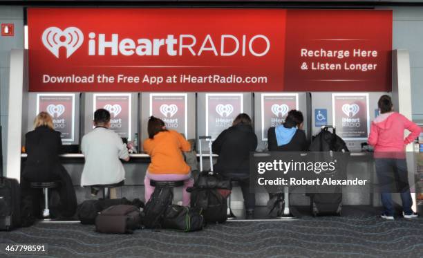 Airline passengers between flights patronize the iHeartRadio facility at Denver International Airport in Denver, Colorado. IHeartRadio is an internet...