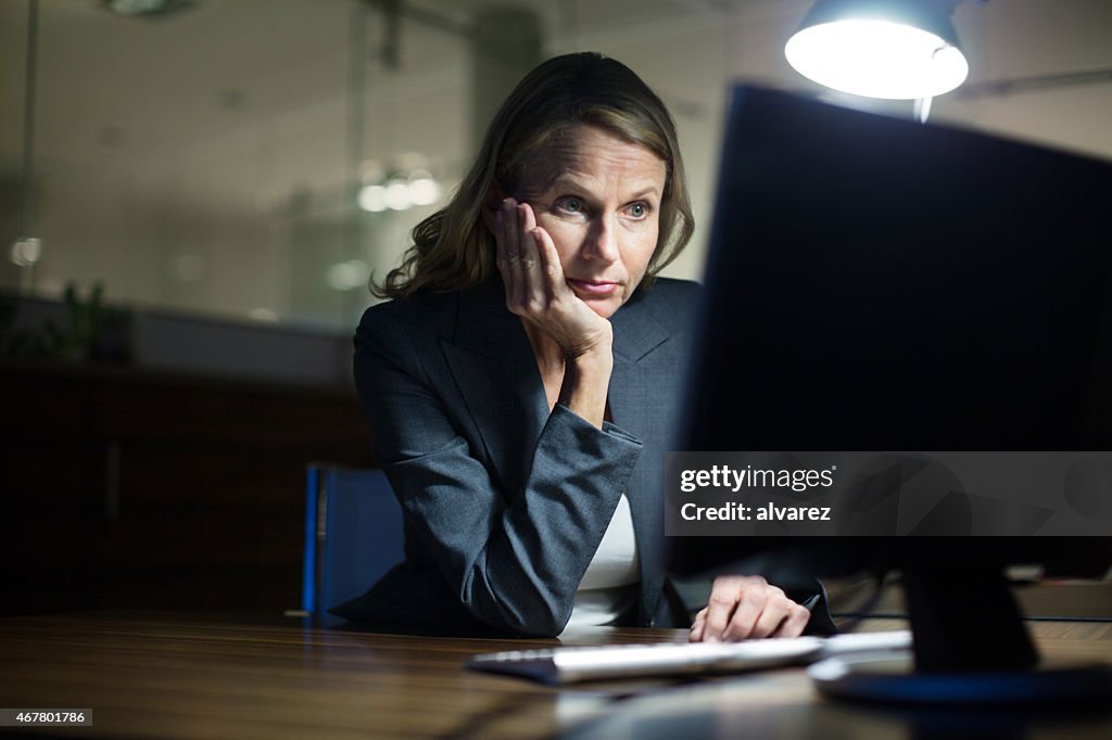 Mature businesswoman working late in office