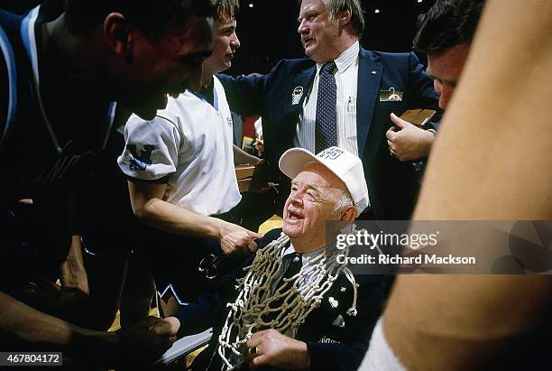 Final Four: Villanova athletic trainer Jake Nevin victorious, seated with cut net after winning championship game vs Georgetown at Rupp Arena. Nevin,...