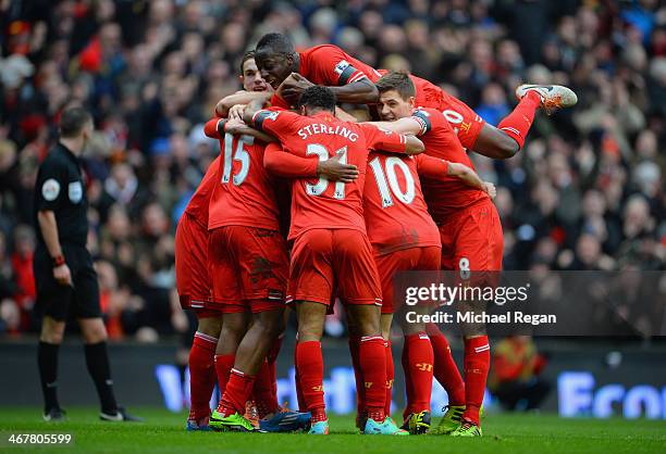 Daniel Sturridge of Liverpool celebrates with his team-mates after scoring the fourth goal during the Barclays Premier League match between Liverpool...