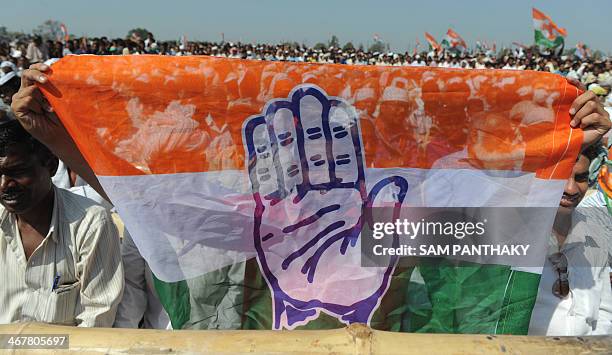 Members of the Congress party hold the party flag during a rally at the conclusion of the Vikas Khoj Yatra at the place where Sardar Vallabhbhai...