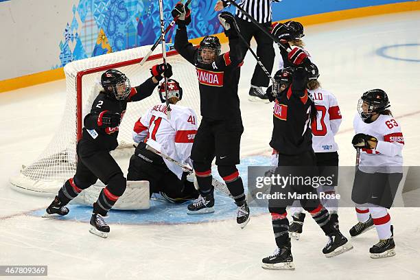 Natalie Spooner, Hayley Wickenheiser and Meghan Agosta-Marciano of Canada celebrate after Jocelyne Larocque of Canada scored a goal against Florence...