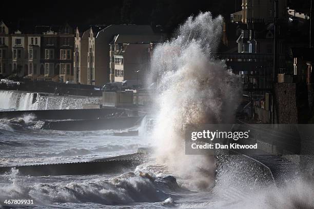 Waves crash over the main Exeter to Plymouth railway line that has been closed due to parts of it being washed away by the sea on February 8, 2014 in...