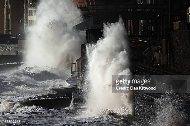 Waves crash over the main Exeter to Plymouth railway line that has been closed due to parts of it being washed away by the sea on February 8, 2014 in...