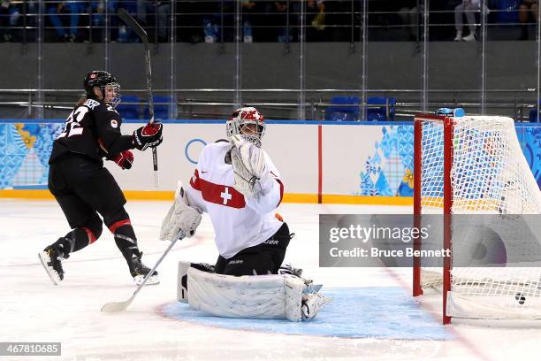 Hayley Wickenheiser of Canada scores a goal against Florence Schelling of Switzerland in the second period during the Women's Ice Hockey Preliminary...