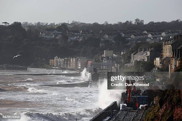 Waves crash over the main Exeter to Plymouth railway line that has been closed due to parts of it being washed away by the sea on February 8, 2014 in...