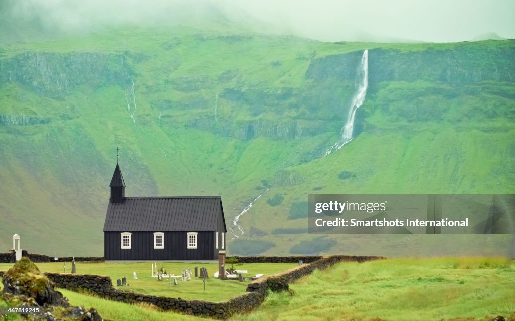 Black church of Budir with landscape and waterfall