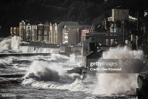 Waves crash over the main Exeter to Plymouth railway line that has been closed due to parts of it being washed away by the sea on February 8, 2014 in...