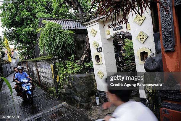 Local resident ride pass a house where Australian drug trafficker Schapelle Corby's sister and brother in law, Mercedes Corby and Wayan Widyartha,...
