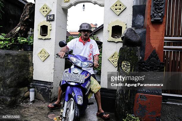 Man rides a motorcycle out of a house where Australian drug trafficker Schapelle Corby's sister and brother in law, Mercedes Corby and Wayan...