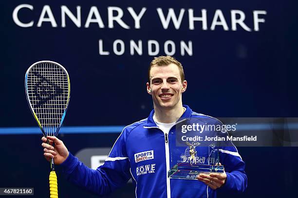 Nick Matthew of Great Britain poses for a photo with the trophy after winning the final against Simon Rosner of Germany during Day 5 of the Canary...