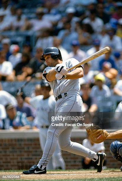 Dante Bichette of the Colorado Rockies bats against the Chicago Cubs during an Major League Baseball game circa 1994 at Wrigley Fields in Chicago,...