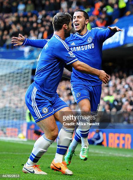 Eden Hazard of Chelsea celebrates with team mate Branislav Ivanovic after scoring during the Barclays Premier League match between Cheslea and...