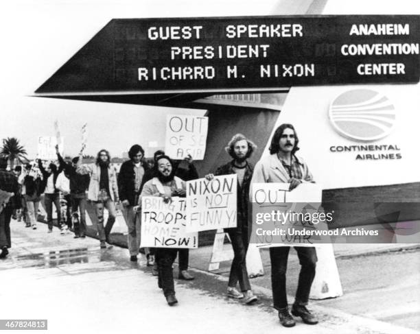 Antiwar demonstrators march in front of the Anaheim Convention Center where Nixon is to speak, Anaheim, California, October 30, 1970. Nixon will...