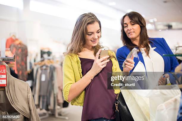 mother and daughter shopping with qr codes - clothing tag stock pictures, royalty-free photos & images