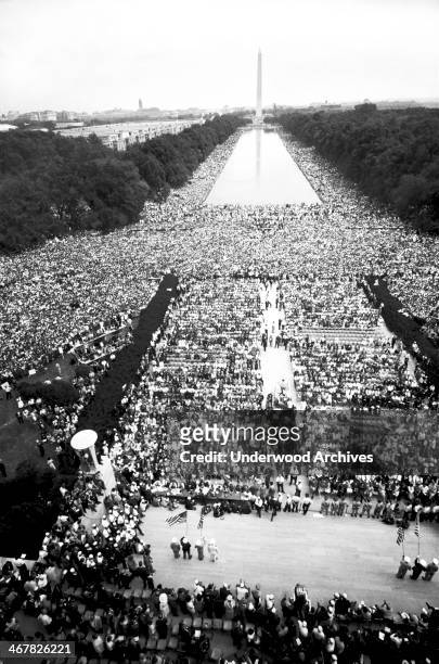 The civil rights march on Washington showing crowds of people on The Mall, starting at the Lincoln Memorial, going around the Reflecting Pool, and...