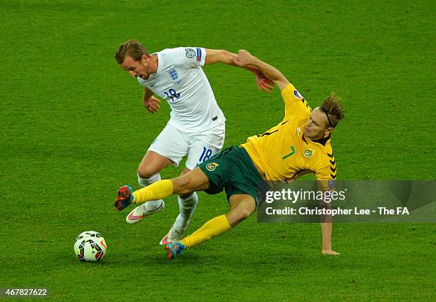 Arturas Zulpa of Lithuania tackles Harry Kane of England during the EURO 2016 Qualifier between England and Lithuania at Wembley Stadium on March 27,...
