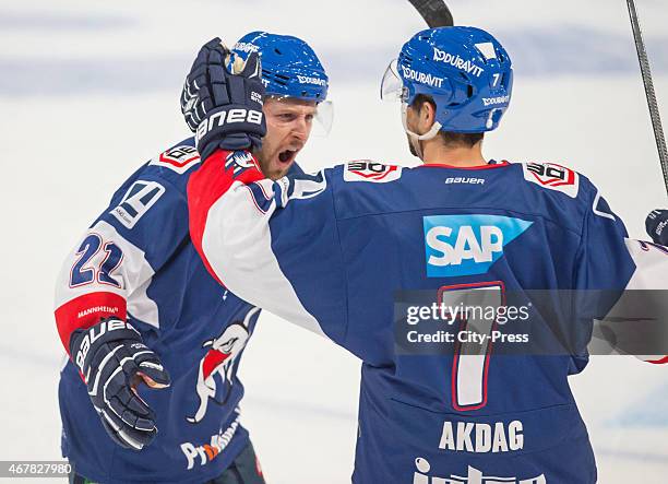 March 27: Robert Raymond of the Adler Mannheim and Sinan Akdag of the Adler Mannheim celebrate after scoring the 5:4 during the game between Adler...