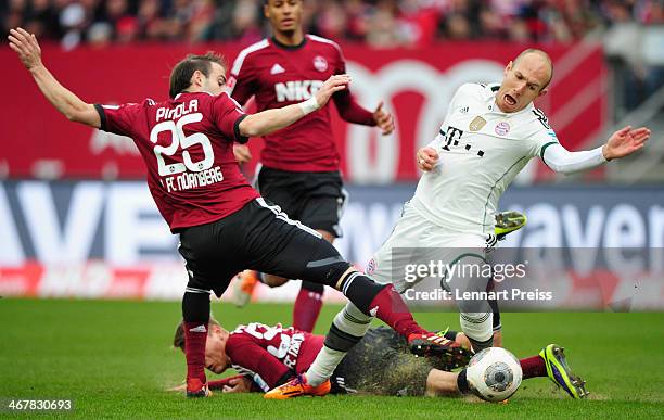 Arjen Robben of Muenchen challenges Javier Pinola and Ondrej Petrak of Nuernberg during the Bundesliga match between 1. FC Nuernberg and FC Bayern...