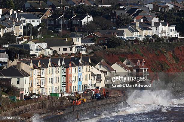 Waves crash over the main Exeter to Plymouth railway line that has been closed due to parts of it being washed away by the sea on February 8, 2014 in...