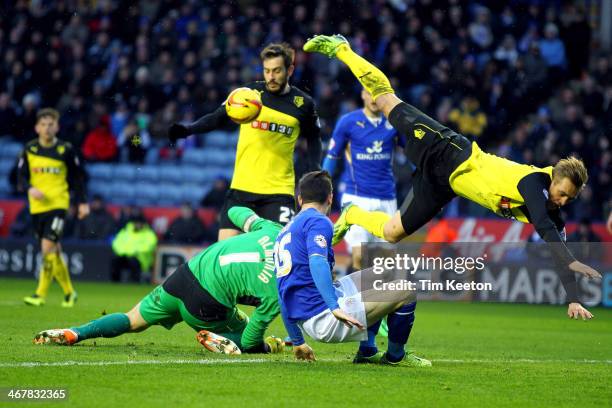 Watford's Joel Ekstrand clatters into his own keeper Manuel Almunia as Leicester City's David Nugent puts pressure on during the Sky Bet Championship...