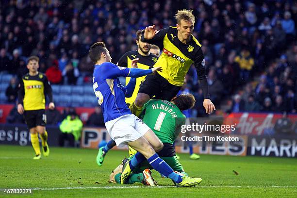 Watford's Joel Ekstrand clatters into his own keeper Manuel Almunia as Leicester City's David Nugent puts pressure on during the Sky Bet Championship...